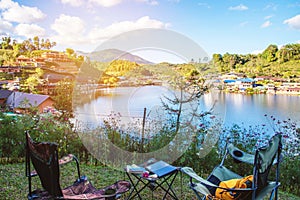 Adventures Camping and And use a working notebook near lake, Concept Travel, Camping Ban Rak Thai village Mae Hong Son in Thailand