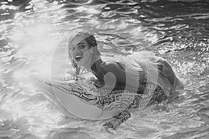 Adventures of girl on crocodile. fashion portrait of a sensual girl. Relax in luxury swimming pool. Fashion