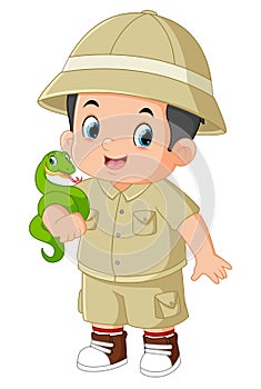 an adventurous boy posing with a green snake
