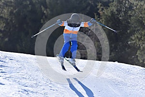 Adventurous Child Skiing: 10-Year-Old Flying off a Snowy Hill