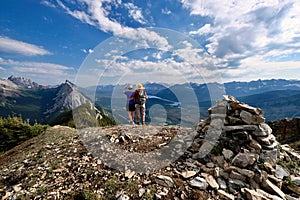 Adventurous couple on mountain top looking at scenic view.