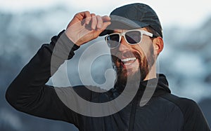 Adventurous explorer man with beard and glasses smiling