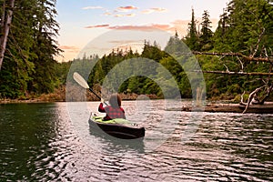 Adventurous Girl kayaking in the Pacific Ocean.