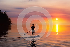 Adventurous girl on a paddle board is paddeling in the Pacific West Coast Ocean