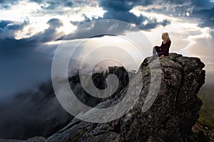 Adventurous Girl on top of a Mountain Peak