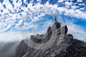 Adventurous Girl on top of a Mountain Peak