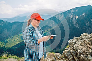 Adventurous lost girl navigating in with a topographic map in the beautiful mountains of the Poland Tatry