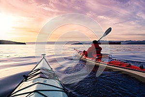 Adventurous Man Sea Kayaking in the Pacific Ocean.