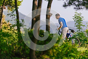 Adventurous mountain biker riding his bike fast through the woods  forest  while enjoying the green nature