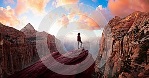 Adventurous Woman at the edge of a cliff is looking at a beautiful landscape view in the Canyon