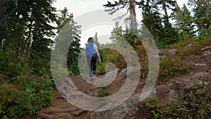 Adventurous Woman Hiker on a hiking trail at top of Canadian Mountain Landscape. St. Mark's Summit