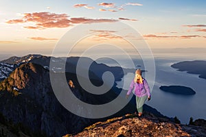 Adventurous woman hiking on the rocky peaks