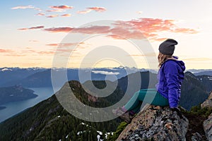 Adventurous woman hiking on the rocky peaks