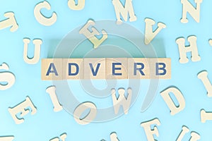 Adverb concept in English grammar and learning class lesson. Wooden blocks typography word flat lay photo