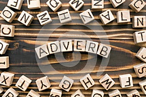 Adverb - word from wooden blocks with letters photo