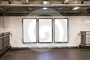 advertisement billboards electronic displays in a subway station in New York City.