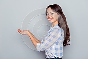 Advertisement concept. Portrait of gorgeous, cute, perfect, cheerful, attractive, caucasian woman showing in two hands copy