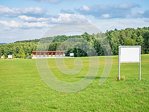 Advertisement flags of Golf club blowing at tee practise range. Practise shot course green