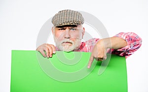 Advertisement shop. Senior bearded man peek out of banner place announcement. Pensioner grandfather in vintage hat hold