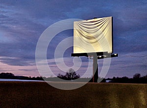 advertising banner billboard by the road is covered with a white cloth. a