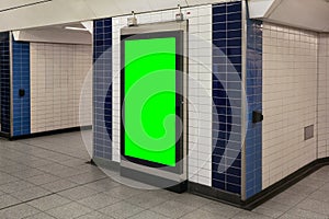 Advertising board display green mockup on wall with white tiles at underground station passage