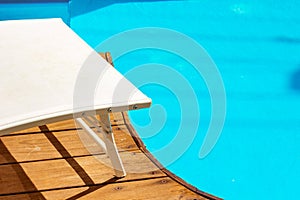 Advertising poster concept of summer relaxation vacation time swimming pool site deck chair furniture white lounge object under