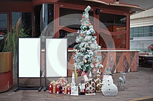 Advertising sign poster placed by an outdoor dinning area of a restaurant, for Christmas decoration.