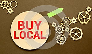 Advice to Buy Local printed on a brown paper price tag as a means of supporting local suppliers and producers