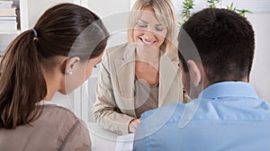 Adviser, broker and customers sitting at desk in the office. photo