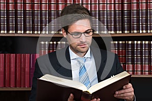 Advocate Reading Book At Courtroom