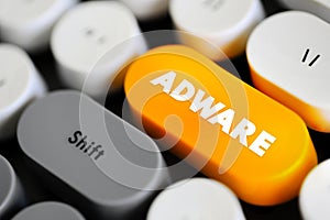 Adware - unwanted software designed to throw advertisements up on your screen, text concept button on keyboard