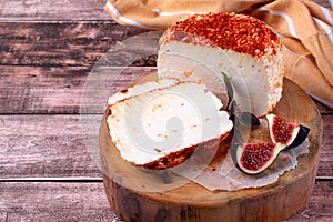 Adyghe cheese sprinkled with smoked paprika and dried tomatoes sliced