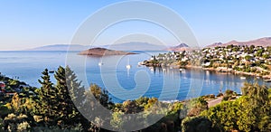 Aegean coast with marvelous blue water, rich nature, islands, mountains and small white houses