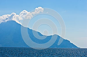 Aegean sea, silhouette of the holy mountains Athos and a small cloud above the mountain top