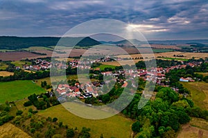 Aer ial view of a German village surrounded by meadows, farmland and forest.