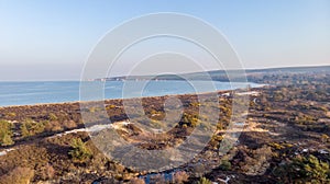 An aerail view of the Studland Nature Reserve with sand dune, peat bog, sea and white cliff in the background under a majestic blu