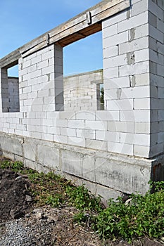 Aerated concrete blocks house wall construction with foundation without waterproofing and windows concrete lintels