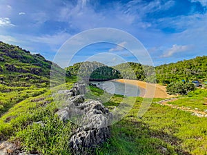 Aereal view of the lagoon sand beach Kasap with green hills