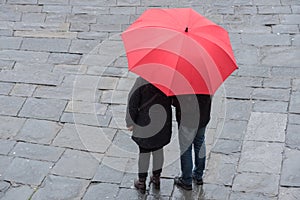 Aereal view of people holding red umbrella