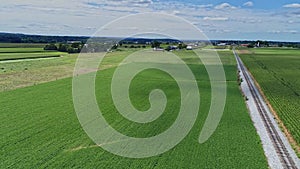 Aerial 180 Degree View of Rich Farmlands and Corn Fields Along a Single Railroad Track