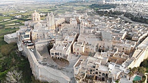 Aerial 4k drone footage panning the horizon over a fortified city on the island of Malta of the Mediterranean Sea.