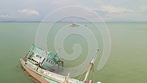 aerial 4K footage of Thai fishing boat sunken ship wreck