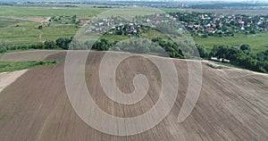 Aerial 4K video of flying drone over the Desna river, Studentsy village and ploughed land from the birds sight