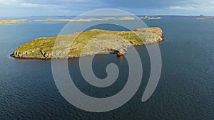 Aerial of an Abandoned ship next to an iseland in Iceland.