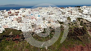 Aerial Above White Houses Beautiful view of Churches in Oia village, Santorini island in Greece