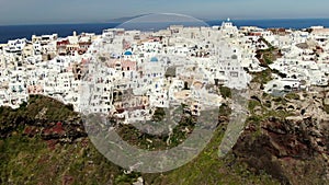 Aerial Above White Houses Beautiful view of Churches in Oia village, Santorini island in Greece