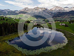 Aerial alpine mountain lake Schwendisee panorama in Wildhaus Unterwasser Toggenburg St Gallen Switzerland alps Europe