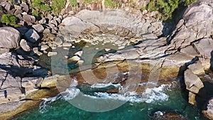 Aerial: Amazing Huge Stones and Waves at Similan Island Cape. HD Slowmotion. Andaman Sea, Thailand.