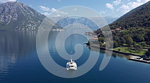 AERIAL. Amazing view to Catamaran cruising in open sea at windy day. Drone view - birds eye angle