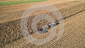 Aerial of an Amish farmer harvesting his corn